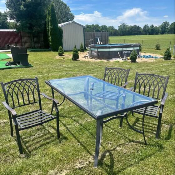 Backyard furniture, a table with a glass top and 3 chairs